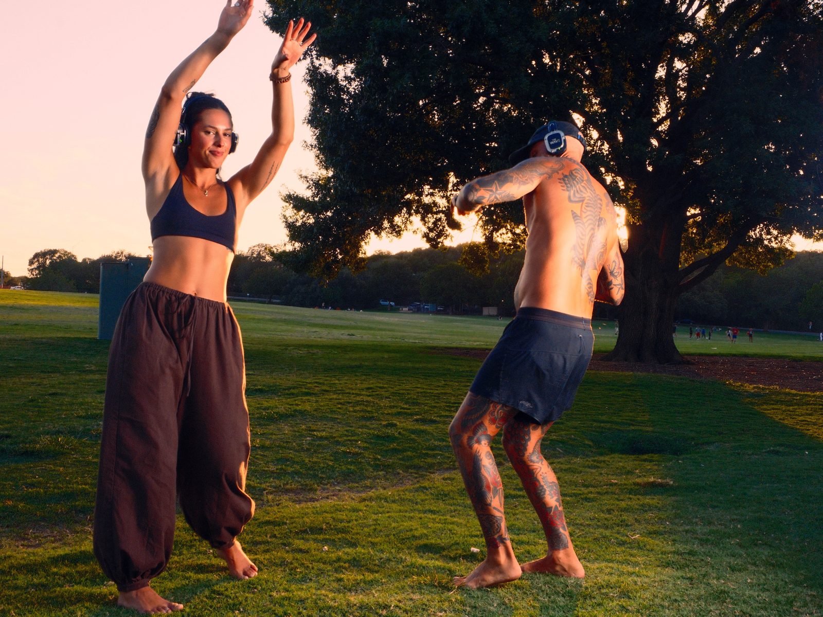 Dancer mid leap with arms raised, celebrating